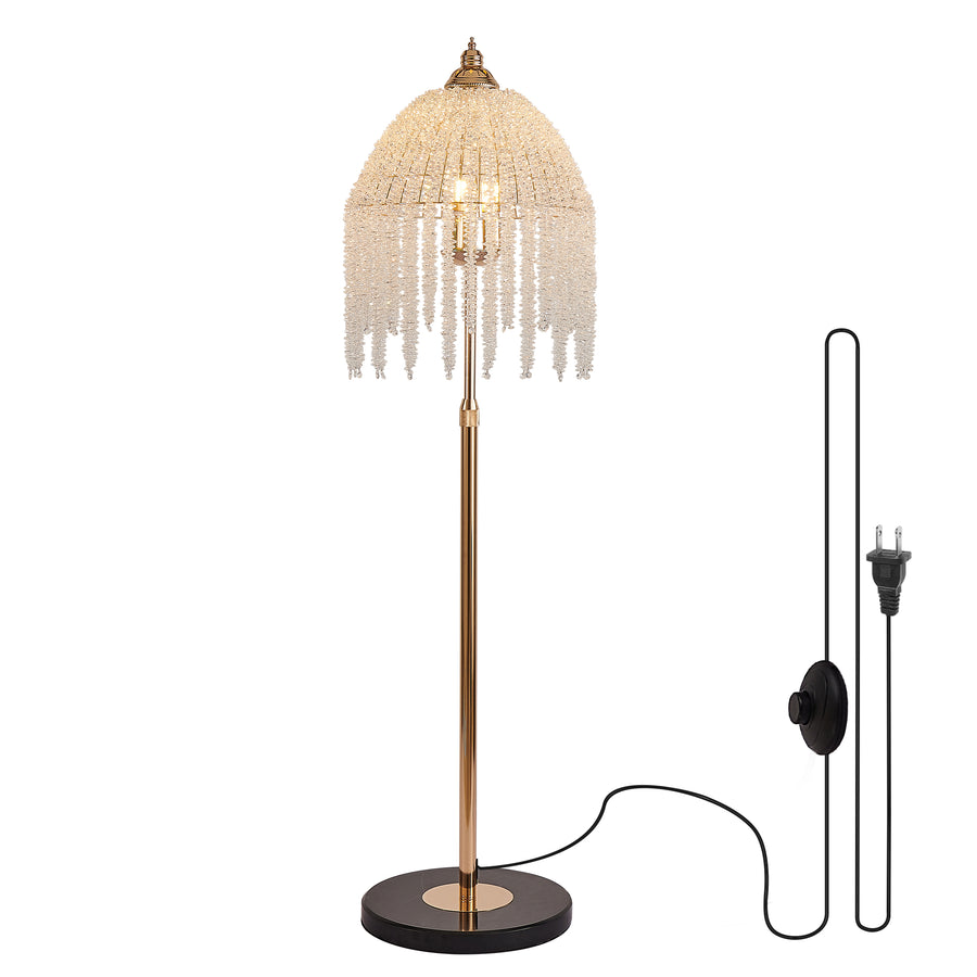 Crystal bead waterfall floor lamp with gold stem, black base, cord and foot switch on white