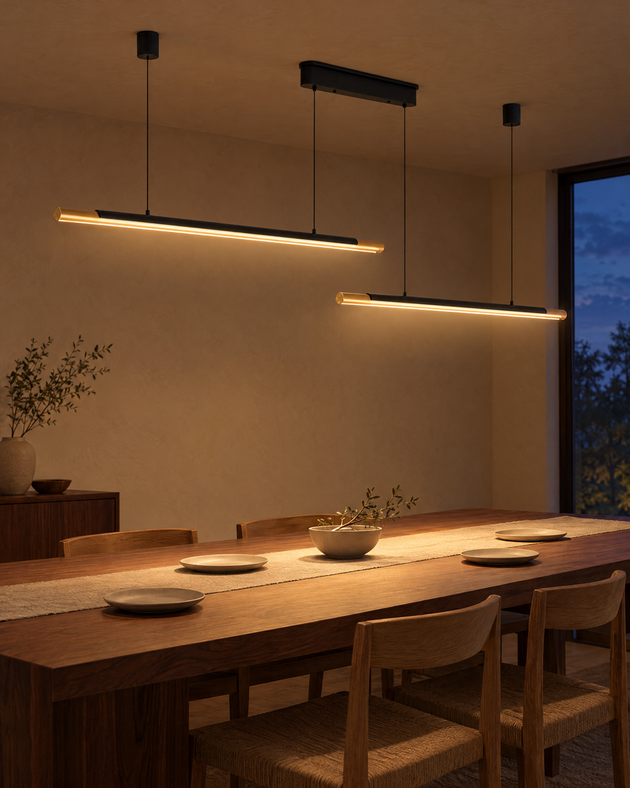 Modern LED Pendant Light, Adjustable Hanging, Black & Gold Finish, 75 in. lit low over a dining table at dusk