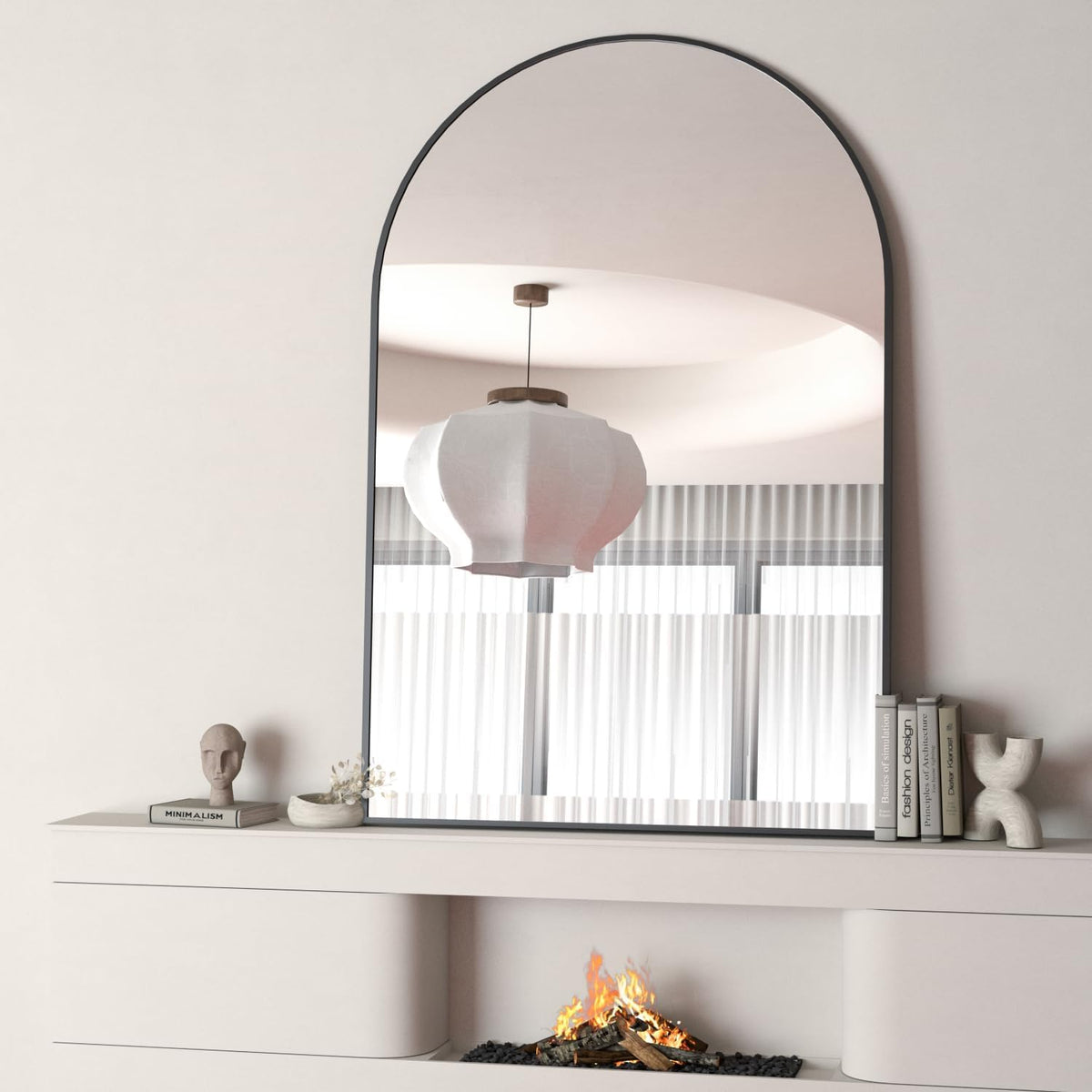 Arched black-frame mirror standing on a white mantel above a fireplace