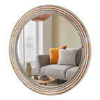 Beaded round wall mirror in whitewashed natural finish on a plain white background