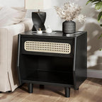 Black cane-front nightstand beside a cream sofa with a twisted black lamp and dried flowers