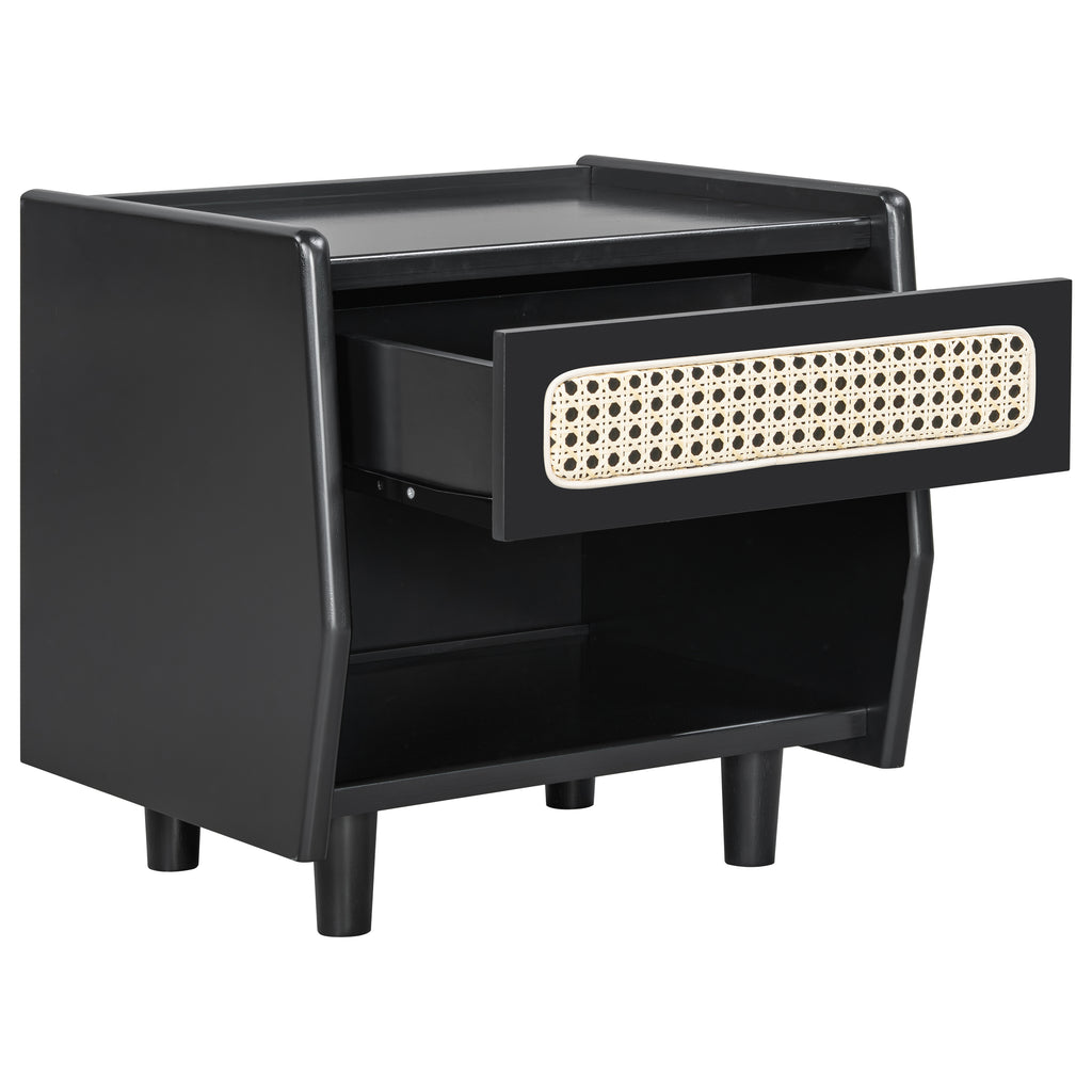 Black nightstand with the cane-front drawer pulled open on a white background