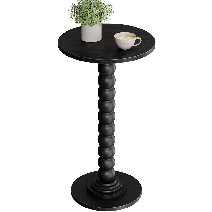 Bobbin pedestal side table in black with a potted plant and cup, on a plain white background
