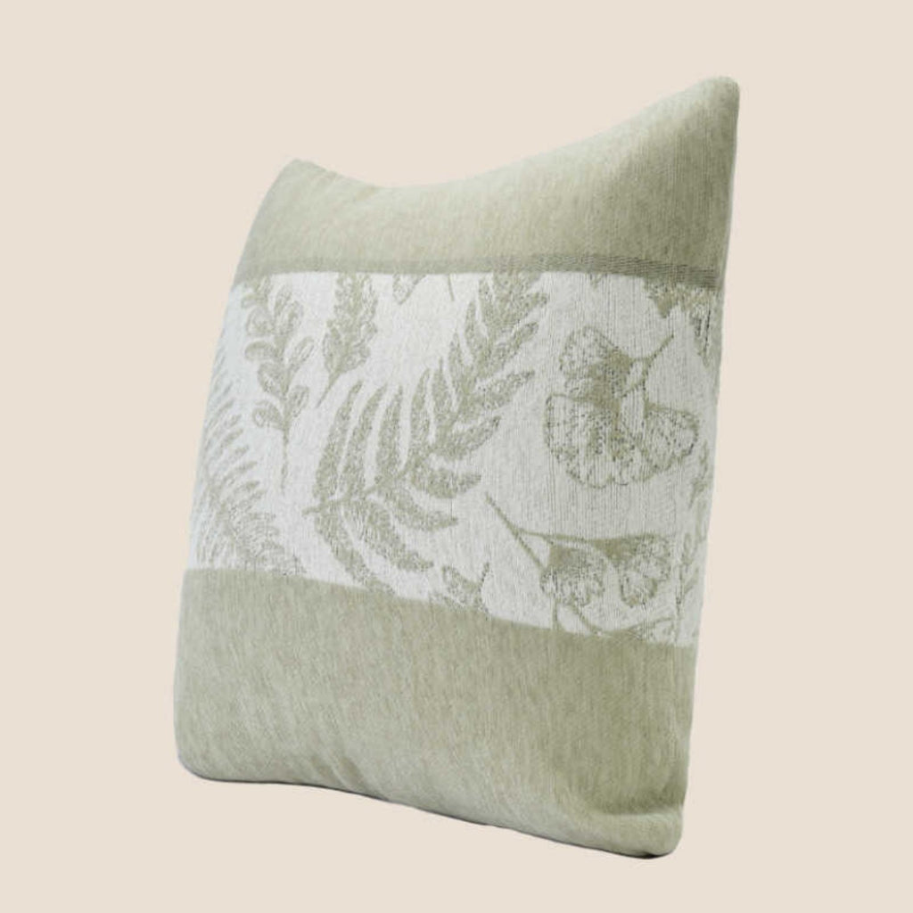Sage fern chenille pillow cover at an angle on a beige background, showing the woven leaf panel and seams