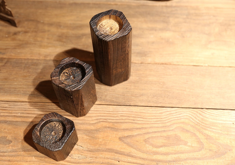 Charred wood tealight holders seen from above — detail of the round tealight wells