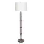 Clear glass column floor lamp with white drum shade and brushed nickel base on a plain black background