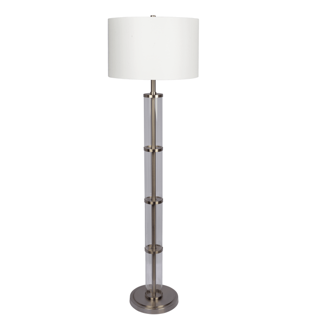 Clear glass column floor lamp with white drum shade and brushed nickel base on a plain black background