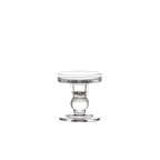 Short clear glass candle holder with a ball stem on a plain white background