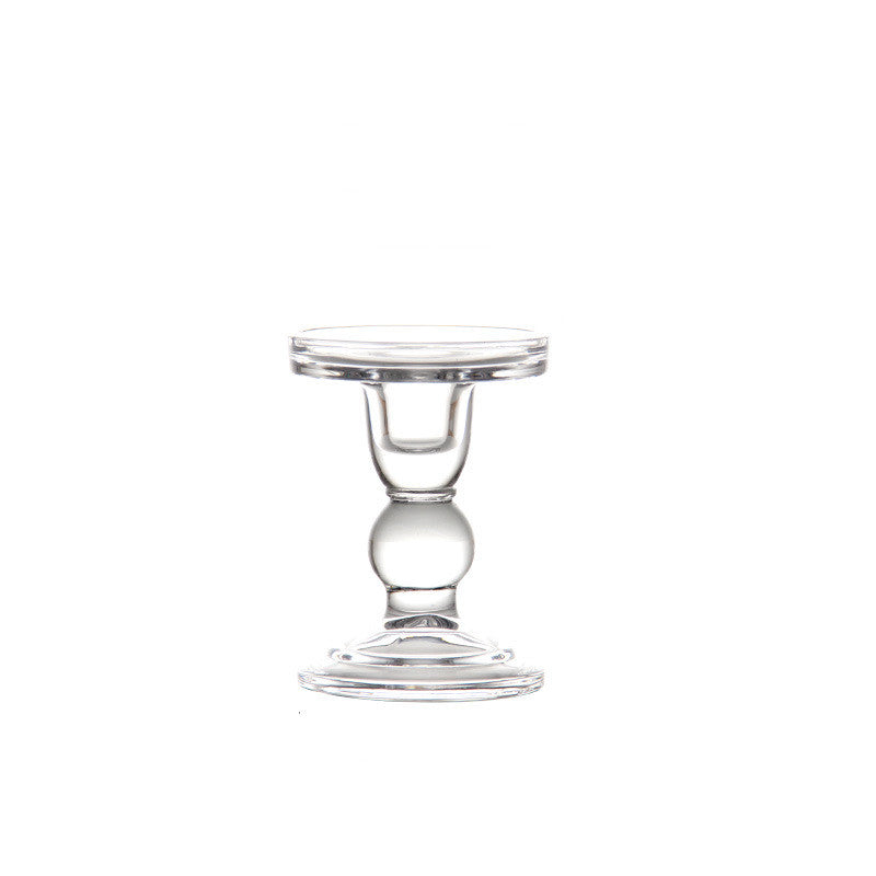 Medium clear glass candle holder with a ball stem and round foot on a plain white background