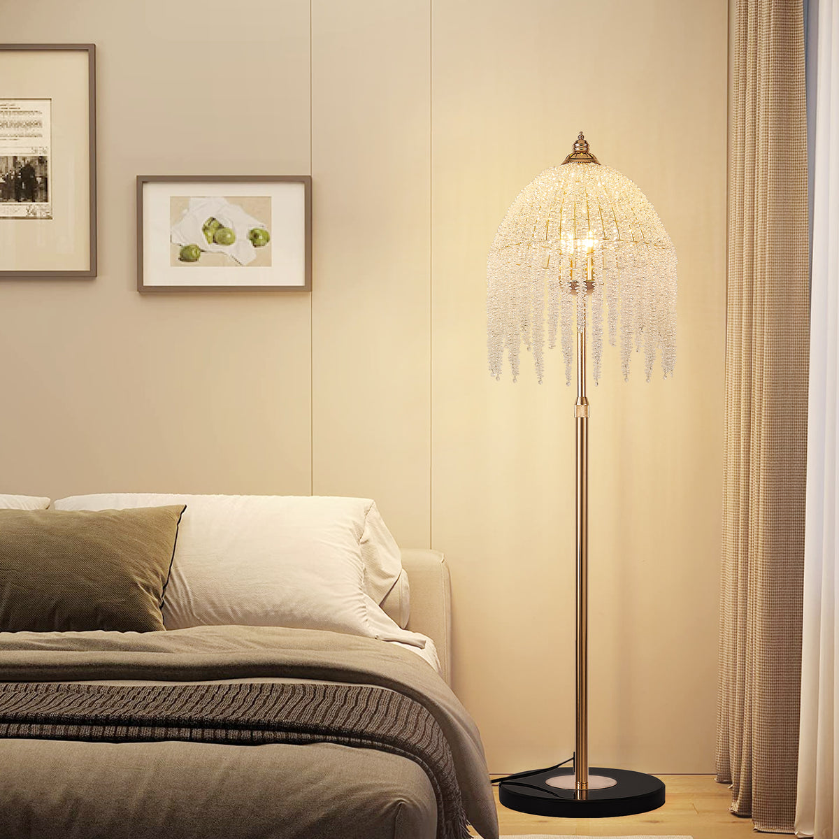 Crystal waterfall floor lamp glowing beside a bed in a cream bedroom