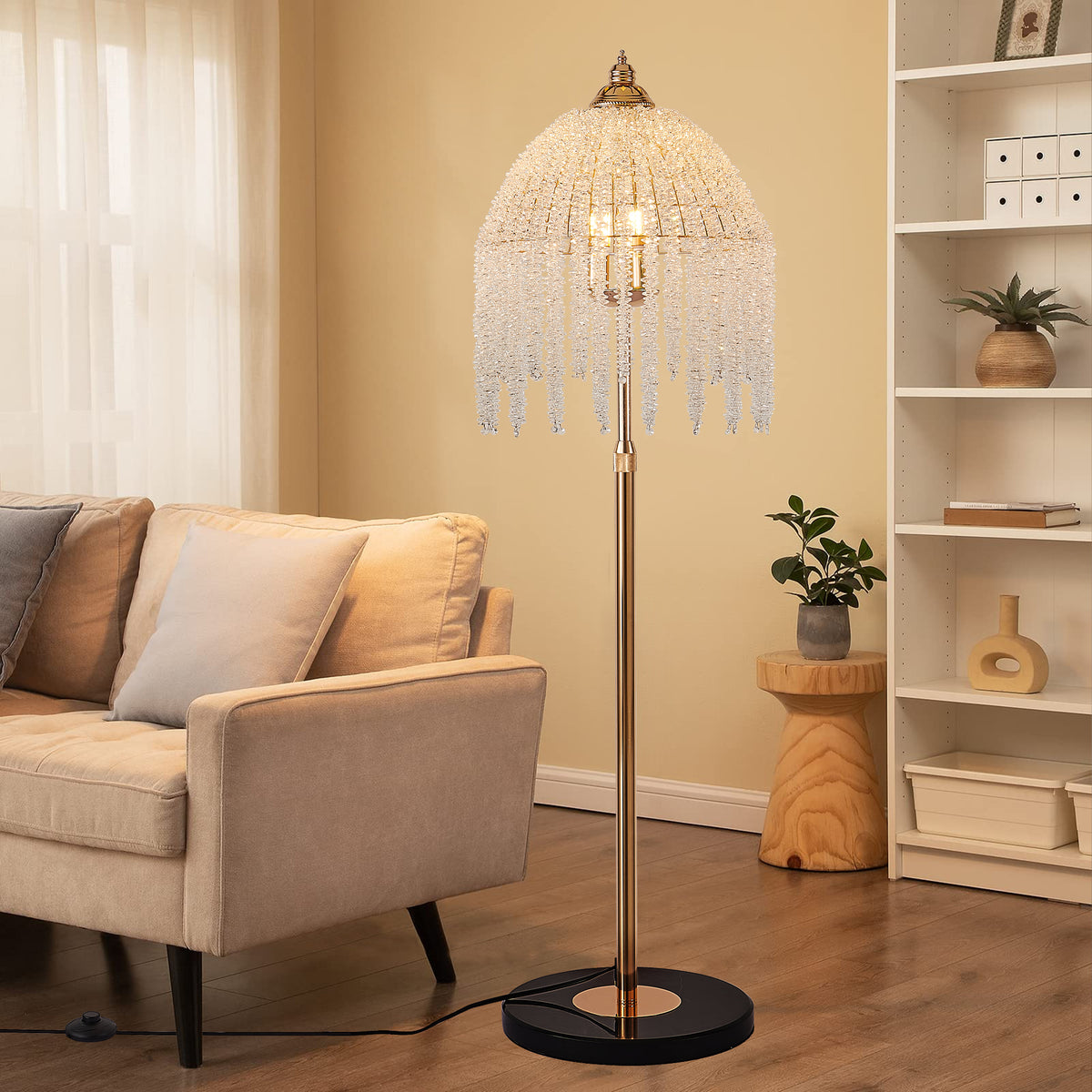 Crystal bead floor lamp lit beside a beige armchair and open shelving