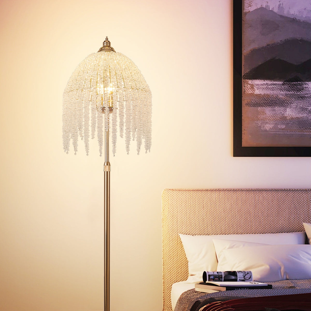Crystal waterfall floor lamp shade lit warm in a bedroom corner by a framed print