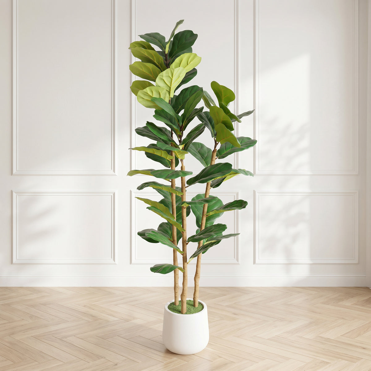 Faux fiddle leaf fig tree in its white pot in a paneled cream room with a herringbone floor