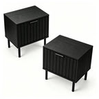 Set of two fluted black nightstands with metal legs on a plain white background