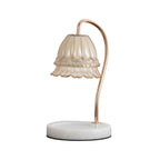 Fluted glass candle warmer lamp with white marble base and gold-tone curved arm on a plain white background