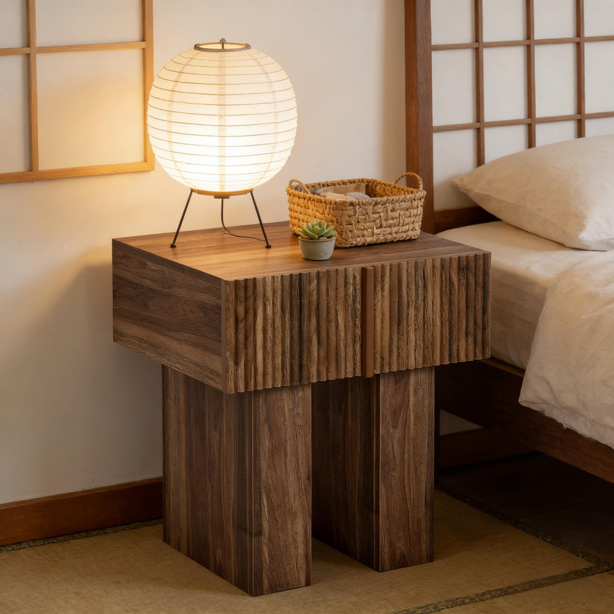 Fluted brown nightstand beside a bed under a lit paper lantern lamp with a woven basket