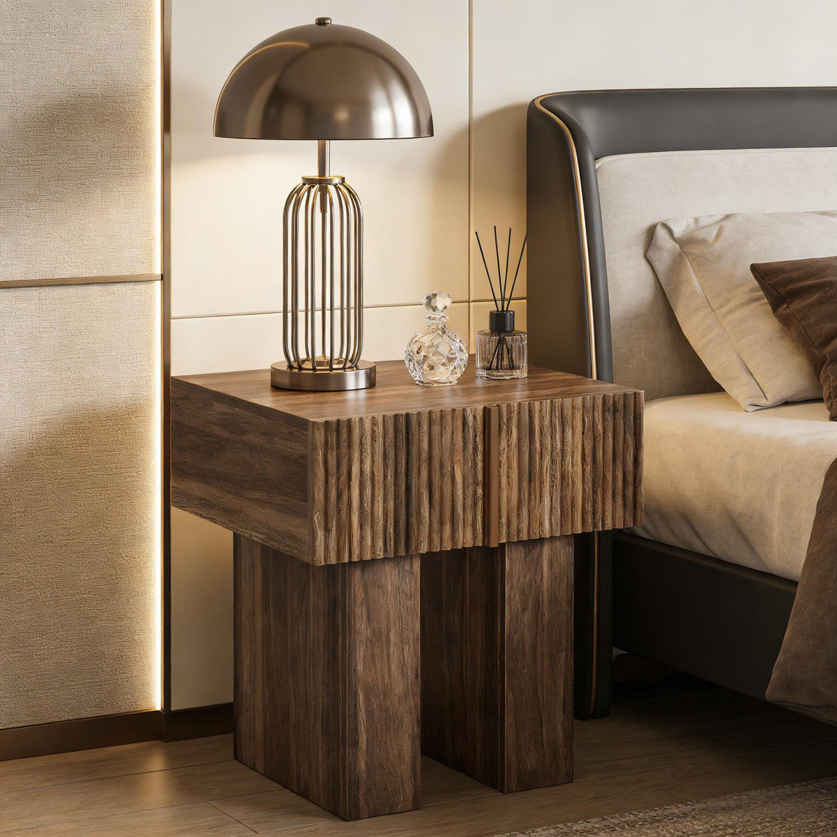 Fluted pedestal nightstand with a metal dome lamp beside a leather headboard