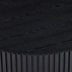 Fluted drum coffee table — detail of the matte black wood-grain top and ribbed edge