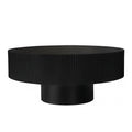 Fluted round drum coffee table in black with pedestal base on a plain white background