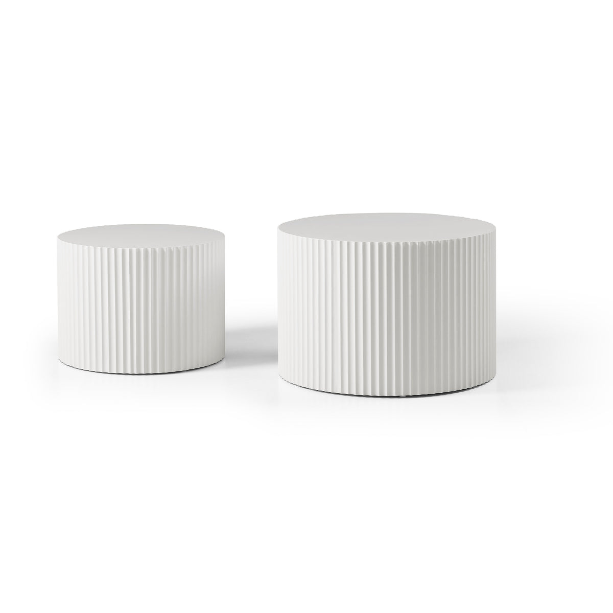 White fluted drum tables side by side, small on the left and large on the right, on a white background