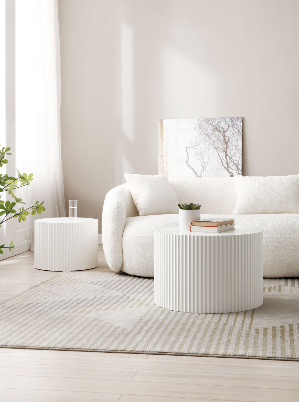 White fluted drum tables used as coffee and side tables beside a cream boucle sofa