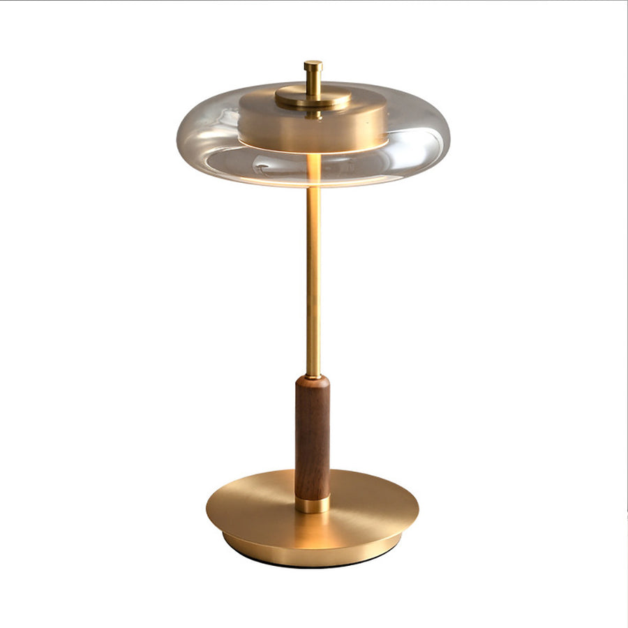 Glass disc table lamp with walnut grip and brass-tone stem on a plain white background