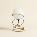 13.5 H Glass Globe Matte Gold Spiral 4 Ring Metal Stand Table Lamp For on a warm cream background