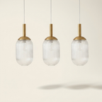 Modern Style Pendant Lamp - Bronze And Clear 110-120V Bedside Lamp Bed on a warm cream background