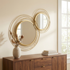 Round Metal Wall Mirror, Asymmetrical Circle Frame, Gold for Entryway styled in a room