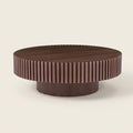 Round Pedestal Coffee Table, Walnut, 31.5 in on a warm cream background