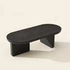 Modern Oval Coffee Table, Matte Black on a warm cream background