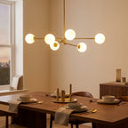Minimalist 6-Light Wrought Iron Chandelier with Glass Shades styled in a warm modern interior