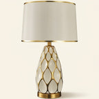 Honeycomb Ceramic Table Lamp, Cream with Gold Trim Shade on a warm cream background