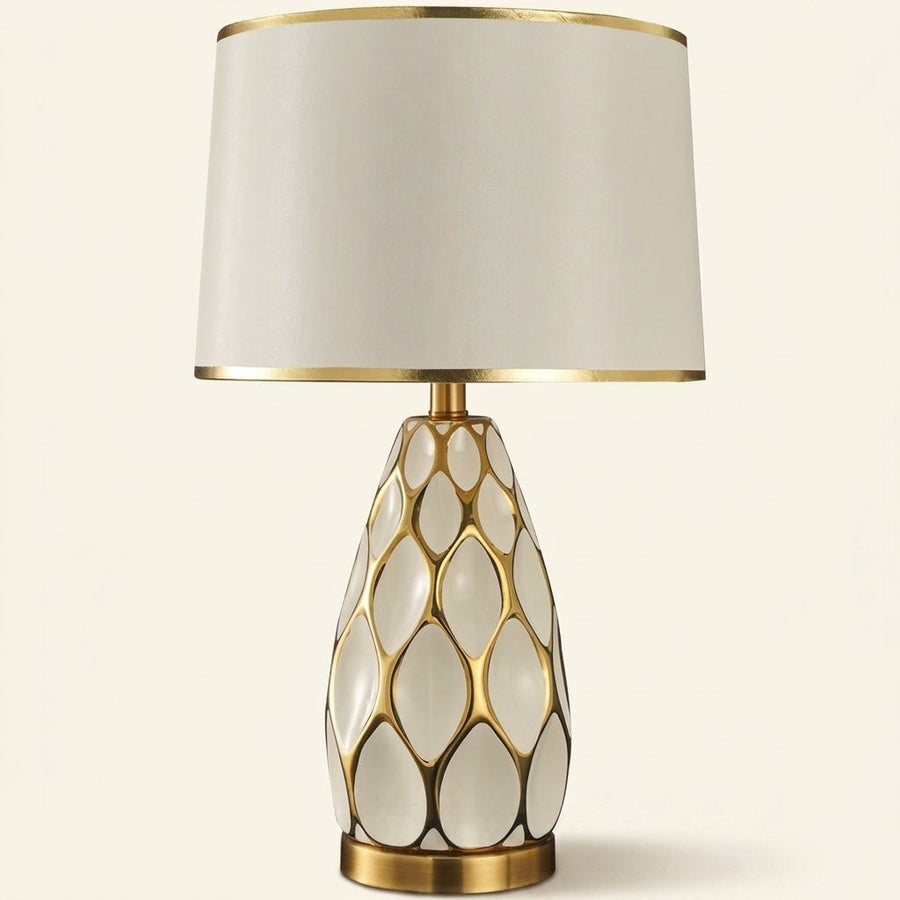 Honeycomb Ceramic Table Lamp, Cream with Gold Trim Shade on a warm cream background