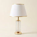 Textured Glass Table Lamp with Lit Base, Gold Trim Shade on a warm cream background