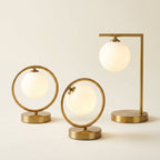 Brass Ring Table Lamp with Opal Glass Globe, Touch Switch on a warm cream background