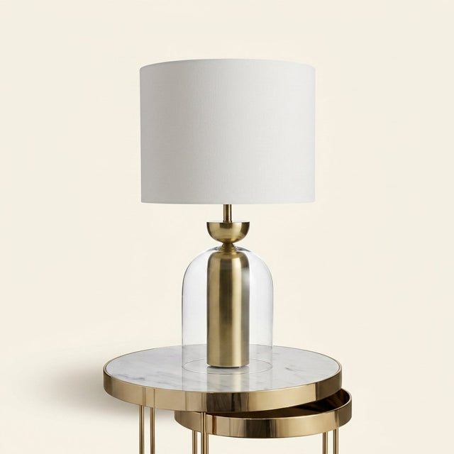 Brass and Glass Cloche Table Lamp, White Drum Shade on a warm cream background