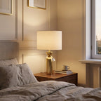 Brass and Glass Cloche Table Lamp, White Drum Shade styled in a warm modern interior