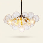 Modern 3-Light Glass Bubble Ball Pendant, 9 Clear Spheres on a warm cream background