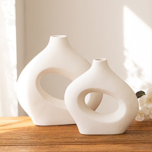 Large and medium ivory hollow ring ceramic vases on a wooden tabletop, sold individually