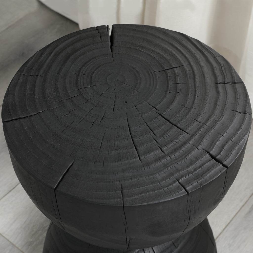 Black mango wood side table — detail of the growth rings and cracks on the round top