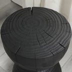Black mango wood side table — detail of the growth rings and cracks on the round top