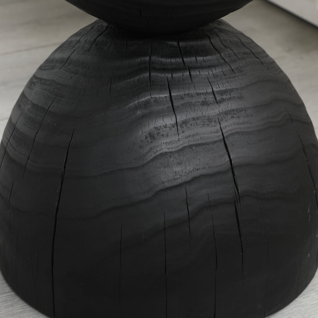 Black mango wood side table — detail of the burnt texture and natural cracks on the lower dome