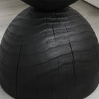 Black mango wood side table — detail of the burnt texture and natural cracks on the lower dome