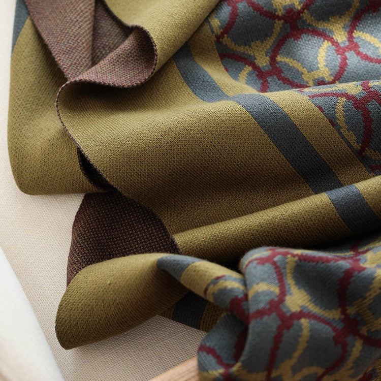 Olive knit throw blanket — detail of the border stripe, ring pattern and solid brown reverse