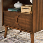 Walnut nightstand — detail of the two raised arched panels on the drawer front and tapered legs