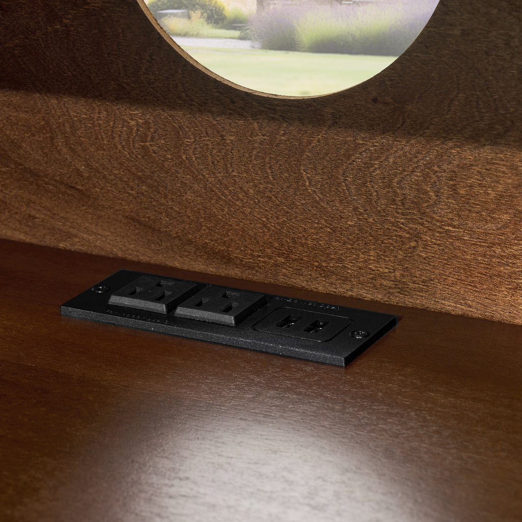 Walnut nightstand — detail of the built-in outlets and USB ports set into the shelf floor