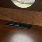 Walnut nightstand — detail of the built-in outlets and USB ports set into the shelf floor