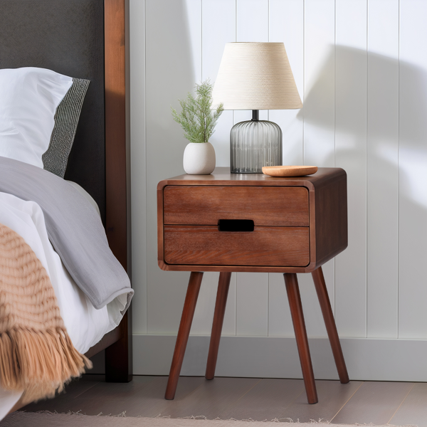 Brown mid-century nightstand beside a bed with a ribbed glass lamp and plant