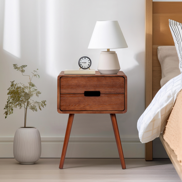 Mid-century nightstand by a bed with a white lamp, clock and potted tree